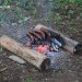 Mini Bushcraft Pack Grill over two logs
